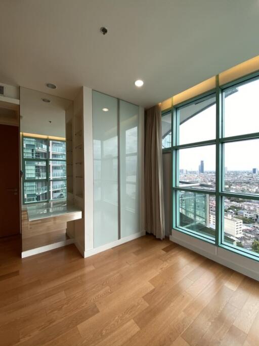 Modern bedroom with large window and city view