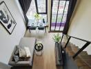 Modern living room with stairs and dining table near window