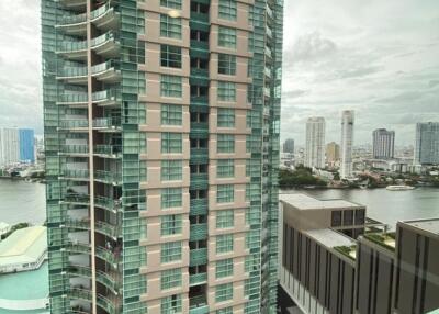 View of a high-rise building from a window showing city skyline and river