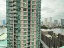 View of a high-rise building from a window showing city skyline and river