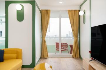 Bright living area with yellow sofa and balcony access