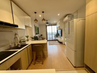 Modern open-plan kitchen-living area with natural light