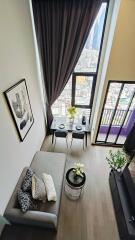 Modern living room with high ceiling and large windows