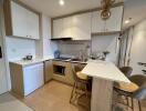 Modern kitchen with dining area and hanging lights