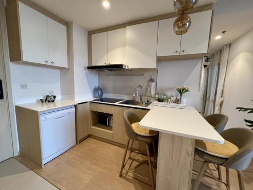 Modern kitchen with dining area and hanging lights