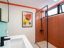 Modern bathroom with shower and abstract art