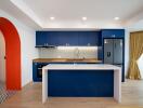 Modern kitchen with blue cabinetry and island