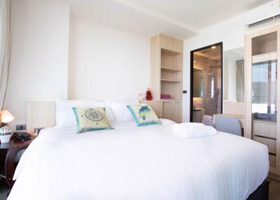 modern bedroom with white bedding and wooden furniture