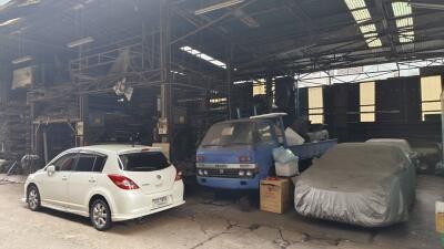 Vehicles parked inside an industrial warehouse