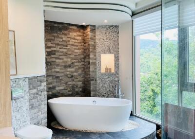 Modern bathroom with a freestanding bathtub and large window