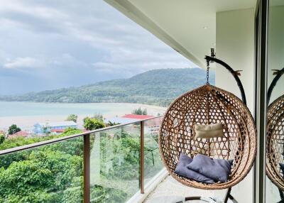 Balcony with hanging chair and mountain view