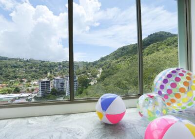 Spacious living area with a panoramic view of the surrounding hills and cityscape.