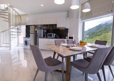 Modern kitchen and dining area with spiral staircase