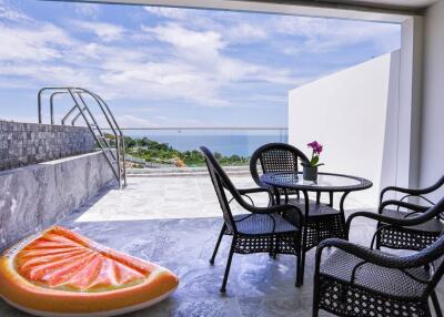 Outdoor patio area with seating and ocean view