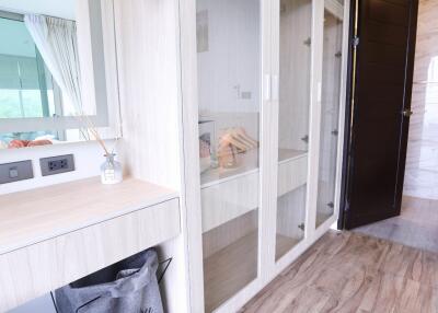 Bedroom with glass closet and wooden floors