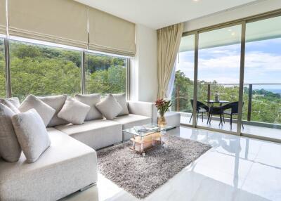 Spacious and modern living room with large windows and scenic view