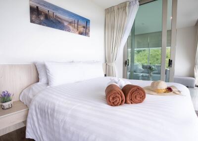 Cozy bedroom with a large bed and glass sliding doors