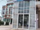 Front facade of a commercial building with large glass windows and door