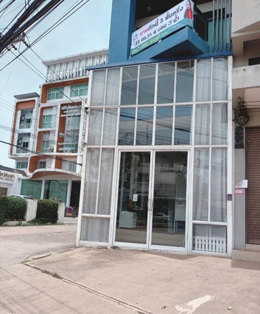 Front facade of a commercial building with large glass windows and door