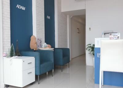 Modern office foyer with blue chairs and white reception desk