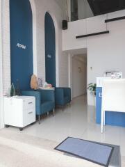 Modern office foyer with blue chairs and white reception desk