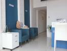 Modern office foyer with blue chairs and white reception desk