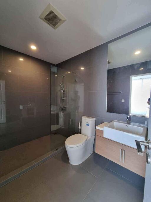 Modern bathroom with glass-enclosed shower and sink