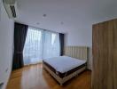 Spacious and bright bedroom with large windows and double bed