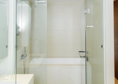 Modern bathroom with glass shower enclosure and bathtub