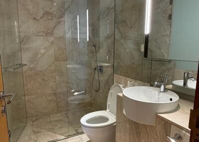 Modern bathroom with glass shower and marble tiles