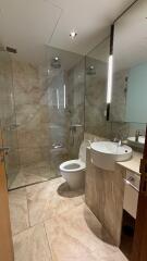 Modern bathroom with glass shower and marble tiles