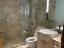 Modern bathroom with glass shower and marble tiles