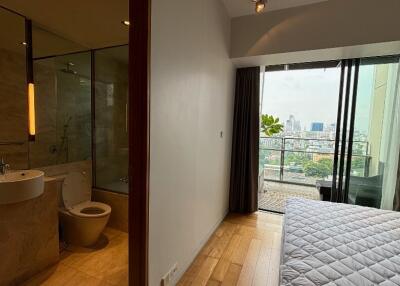 Bedroom with attached bathroom and balcony view