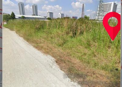 Plot of land with nearby buildings and clear sky