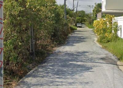 Narrow street view leading to property