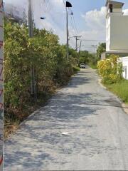 Narrow street view leading to property