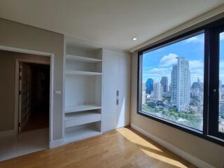 Bedroom with built-in shelves and large window