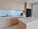 Modern kitchen with wooden cabinetry and island