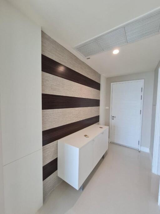 Modern hallway with decorative wall and storage unit