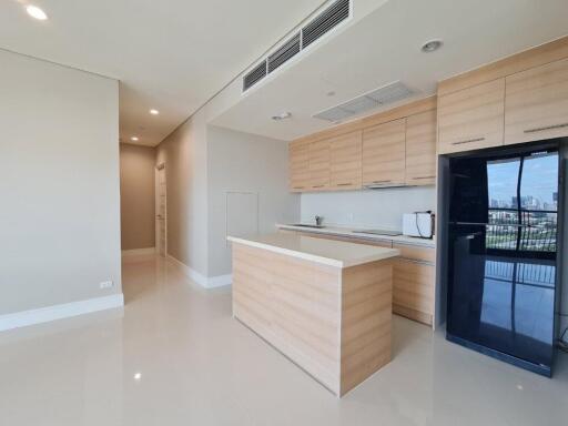 Modern kitchen with light wood cabinets and island