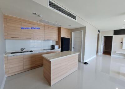 Modern kitchen with wooden cabinets, central island, and appliances.