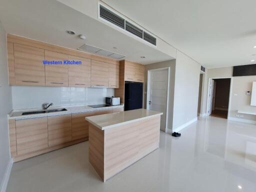 Modern kitchen with wooden cabinets, central island, and appliances.