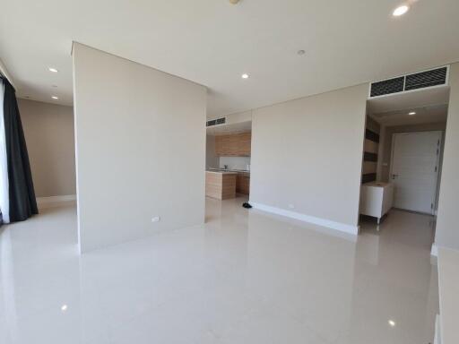 Open-plan living area with a view into the kitchen