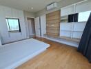 Modern bedroom with wooden flooring and built-in storage