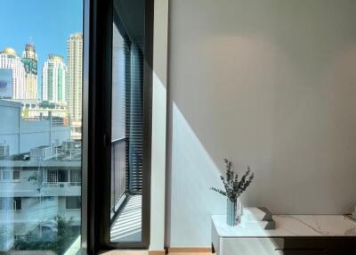 Bedroom with large glass window and city view