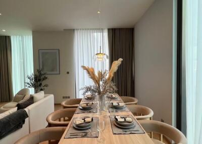 Modern dining room with a set table and large windows