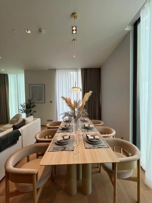 Modern dining room with a set table and large windows