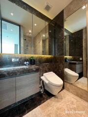 modern bathroom with large mirrors and marble accents