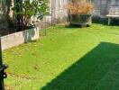 Sunny outdoor garden with artificial green grass