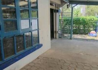 Covered outdoor patio with blue-framed windows